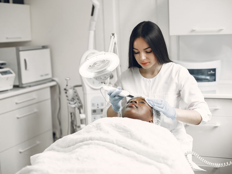 Doctor performing a scalp and hair treatment
